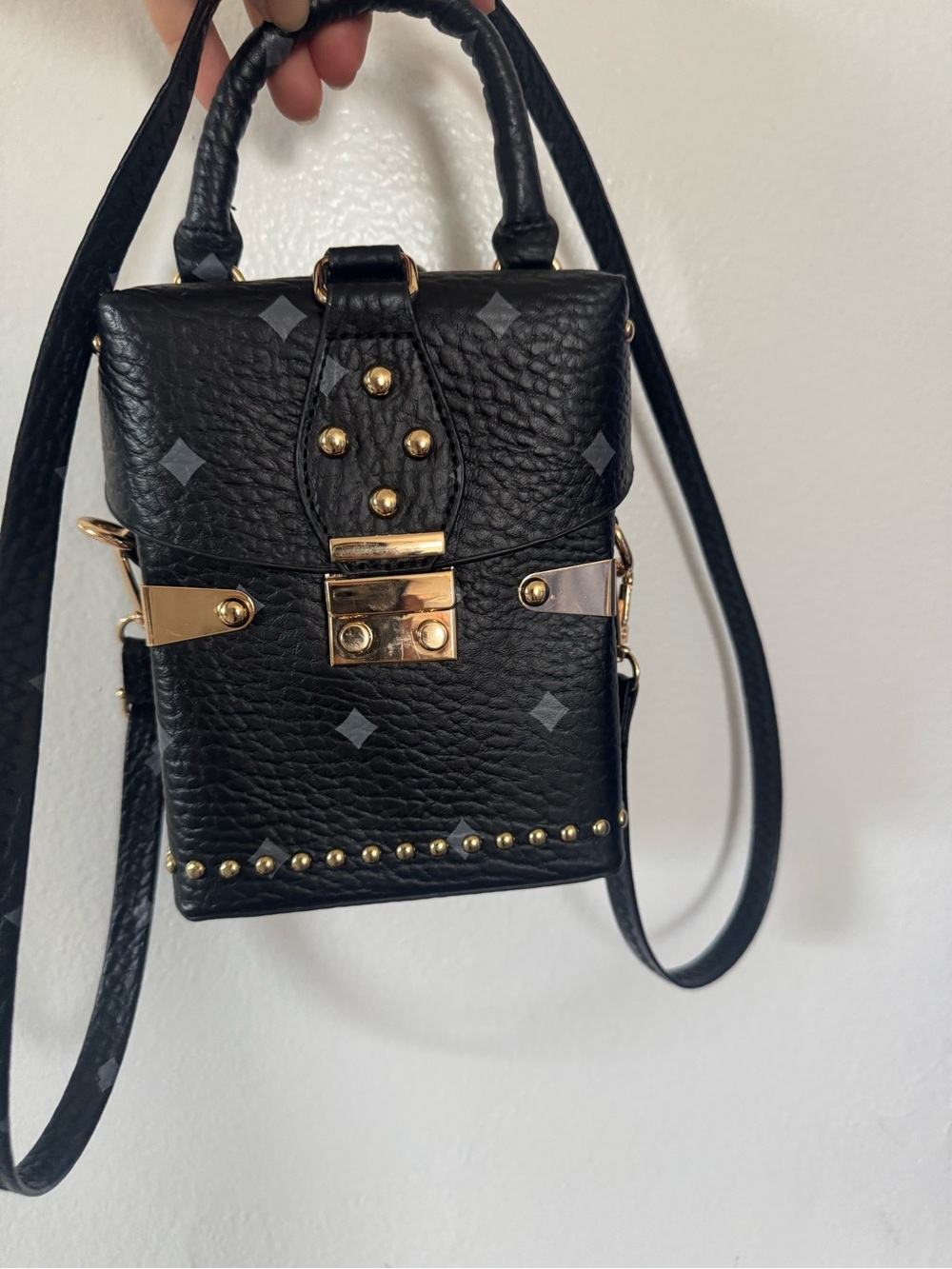Black box shaped crossbody bag with gold hardware